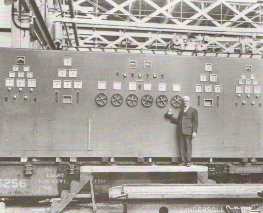 Elmer Woodward with his smallest and largest Woodward governor controls ca  1937